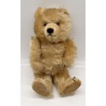 A vintage Chiltern Ting-a-Ling teddy bear circa 1950's with orange and black glass eyes, short