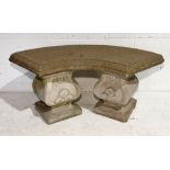 A concrete garden bench with curved seat