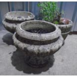 Two matching reconstituted stone garden planters, plus one other. Approximate height 35cm.