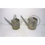 Two galvanised watering cans.