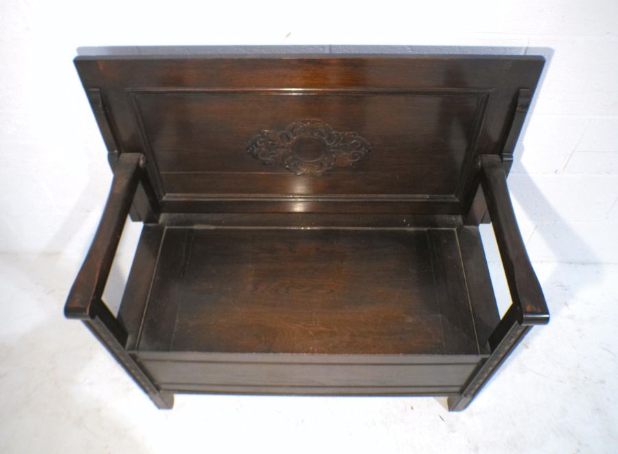 An oak monk's bench with lift up seat and carved detailing, marked 'Raleigh Furniture', length - Image 5 of 9