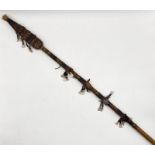 A painted African spear with animal fur and teeth detailing