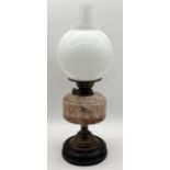 A turn of the century oil lamp with globular shade and marble effect glass well - height 42cm