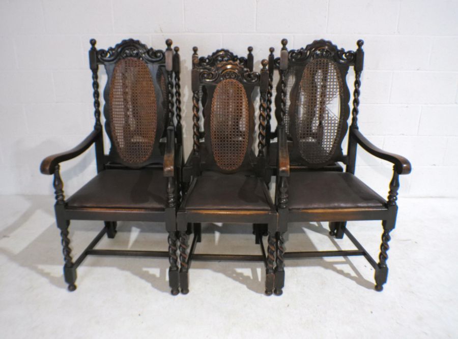 A set of six oak dining chairs with barley-twist legs and cane backs including two carvers - three