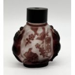 A signed Chinese cameo scent bottle decorated with stylised fish, birds and lions with wooden lid-