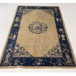 A Chinese blue ground rug decorated with vase and floral forms - 238cm x 133cm