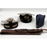 A Royal Navy officer's cap along with a forage cap (possibly Russian), and similar Russian navy