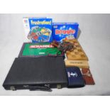 A small collection of various games including Boggle, Scrabble, chess set, backgammon, domino,