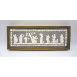 A Wedgwood jasperware plaque in black of a classical scene depicting Psyche bound to a tree whilst
