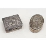 Two hallmarked silver pill pots, one with embossed cherubs and the other depicting "The Life Guards"