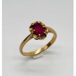 A 10ct gold ring set with a synthetic ruby