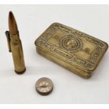 A Queen Mary tin, trench art lighter and small German marked compass