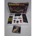 A boxed Scalextric Le-Mans 24 Hour set with two additional F1 racing cars and lap counter