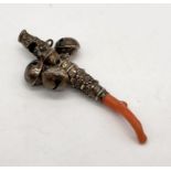 A mid-19th century baby's unmarked silver and coral teether, whistle and rattle, length 8cm
