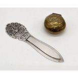 A continental silver (830) book mark along with a small brass lidded pill box