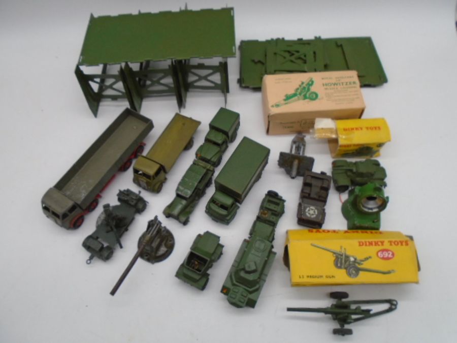 A collection of mainly Dinky Toys military die-cast vehicles and weapons including wagons, tanks,