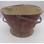 A vintage galvanised weathered red bucket.