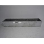 A large galvanised trough. 244cm x 49cm