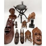A collection of wooden carved African masks, bowls, elephants etc