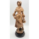 A bronzed spelter figure of a lady by L & F Moreau raised on wooden plinth