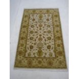 An Indian beige ground rug - Overall size 180cm x 116cm