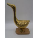 A brass figure of a goose on wooden plinth, height 37cm
