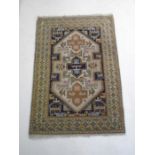 A blue ground rug with geometric design - 260cm x 180cm