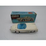 A vintage boxed Corgi Toys die-cast Mercedes-Benz 300SL Open Roadster (No 303) with white body and