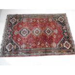 An Eastern red ground rug - 260cm x 180cm