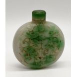 A Chinese jade snuff bottle with carved decoration, height 6.3cm incl. lid