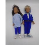 Two unboxed vintage Sasha dolls, one in blue/white checked dress with leggings