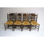 A set of eight oak ladder-back chairs with rush seating.