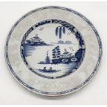 An antique Delft tin glazed plate/bowl with typical blue and white Chinoiserie pattern, stilt