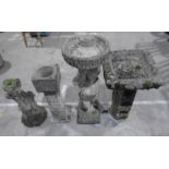 Four garden ornaments including a statue, birdbaths etc