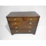 A Georgian mahogany chest of five drawers on bracket feet
