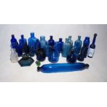 A collection of blue glass bottles etc.