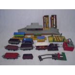 A collection of mainly Hornby O gauge model railway including wagons, level crossing, tinplate