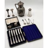 A cased silver Christening set, silver handled knives, small quantity of silver cutlery, Eastern