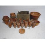 A collection of various sized terracotta garden pots etc - some stored in a wooden crate