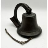A ship's bell on wall bracket - height of bell 16cm