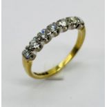 A diamond seven stone half eternity ring set in 18ct gold