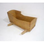 An antique pine rocking cradle, length 96cm.