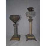 A Victorian alabaster and brass oil lamp along with a cast metal oil lamp base