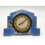 An Art Deco silver and blue enamel eight day Swiss clock hallmarked Birmingham 1931. Damage to the