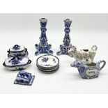 A collection of blue and white china along with two cow creamers, one Staffordshire style and the