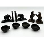 A cast metal pair of bookends in the form of bears along with four carved cups etc.