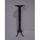A wooden torchere with carved detailing - height 123cm