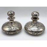 A pair of silver overlaid glass scent bottles