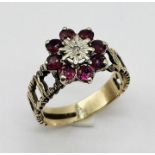 A 9ct gold ring set with rubies and central diamond