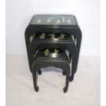 A nest of three black lacquered Chinoiserie tables with carved mother of pearl decoration